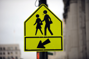 A traffic sign pointing to a pedestrian