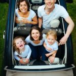 Happy family in a car. Premier Law Group Personal Injury Attorney