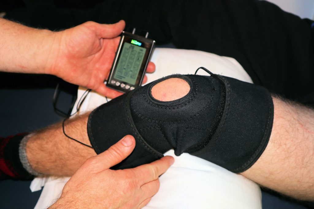 Knee brace on mans knee after a patellar fracture